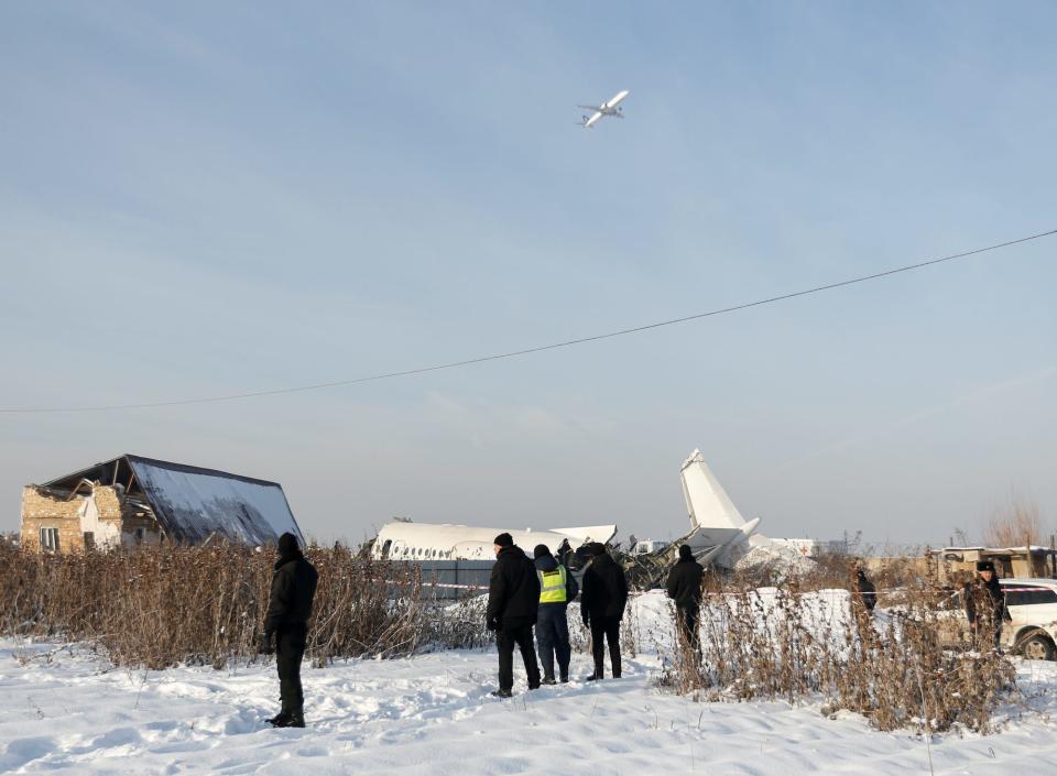 Emergency and security personnel are seen at the site of a plane crash near Almaty, Kazakhstan, December 27, 2019. REUTERS/Pavel Mikheyev