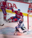 Montreal Canadiens' Joel Armia (40) celebrates with teammate Paul Byron (41) after scoring a shorthanded goal on Winnipeg Jets goaltender Connor Hellebuyck (37) during the second period of an NHL Stanley Cup playoff hockey game in Montreal, Sunday, June 6, 2021. (Ryan Remiorz/The Canadian Press via AP)