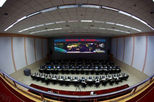 Chinese technicians at the Jiuquan Space Centre monitor the Shenzhou-9 spacecraft. The crew had successfully carried out China's first manual space docking with the orbiting Tiangong-1 module, a difficult move that is essential in the process of building a space station -- which Beijing aims to do by 2020