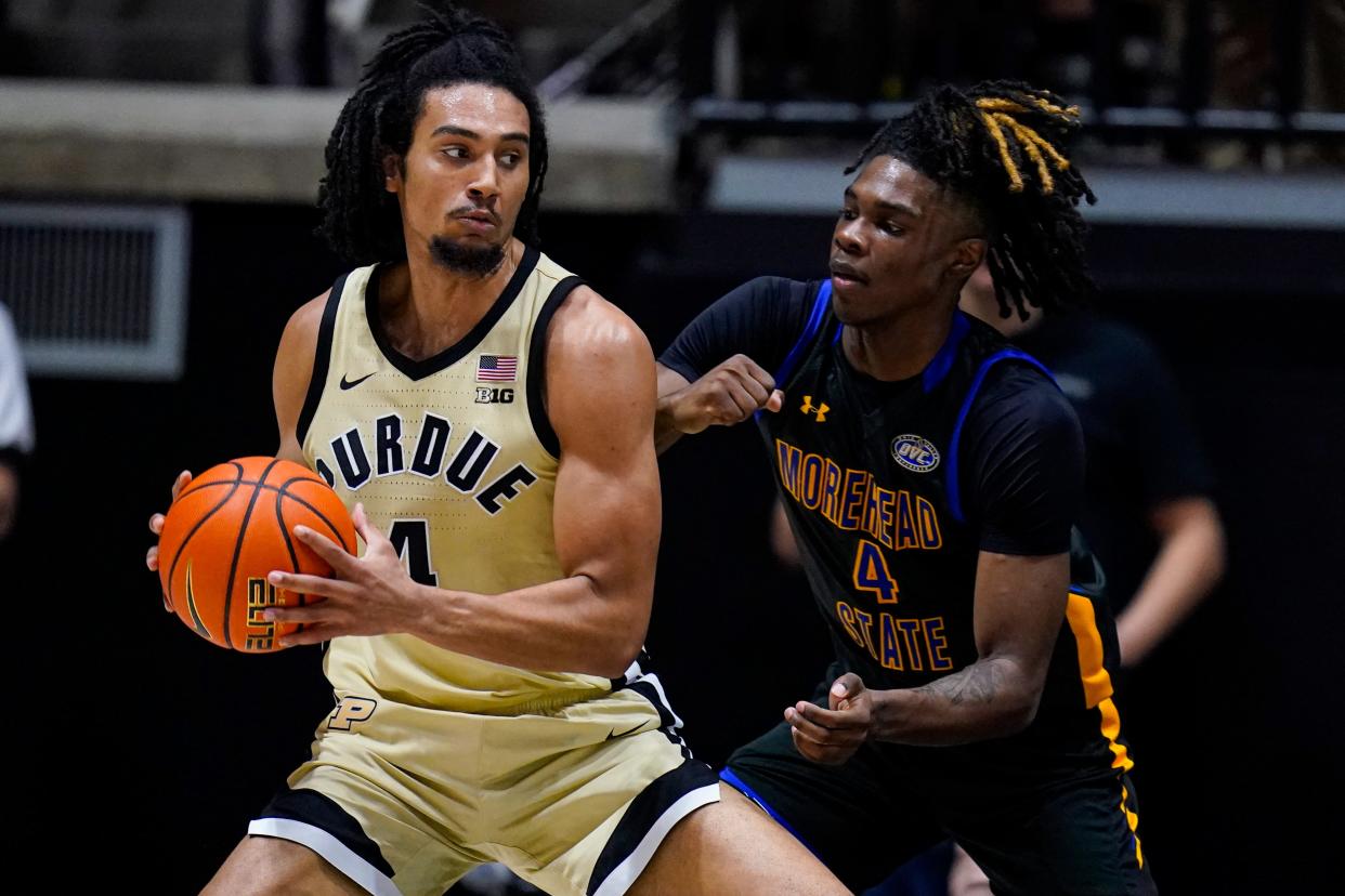 Purdue forward Trey Kaufman-Renn (4) drives on Morehead State guard Eddie Ricks III (4) during the first half of an NCAA college basketball game in West Lafayette, Ind., Friday, Nov. 10, 2023. (AP Photo/Michael Conroy)