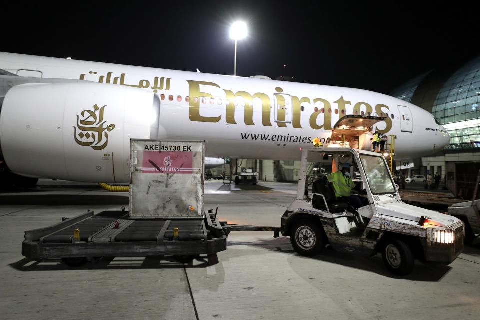 A Pfizer-BioNTech COVID-19 coronavirus vaccine shipment is offloaded from an Emirates Airlines Boing 777 that arrived from Brussels to Dubai International Airport in Dubai, United Arab Emirates, early Sunday, Feb. 21, 2021. As the coronavirus pandemic continues to clobber the aviation industry, Emirates Airlines, the Middle East’s biggest airline is seeking to play a vital role in the global vaccine delivery effort. (AP Photo/Kamran Jebreili)