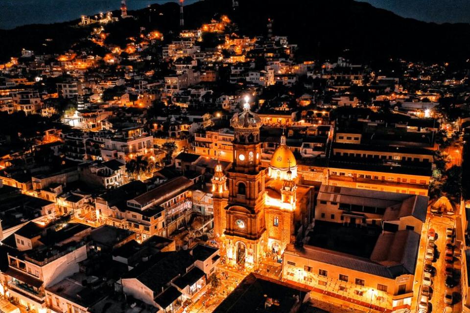 Puerto Vallarta is among the safest places to visit in Mexico and has stunning views. Pictured: city lights brightening the night view in Puerto Vallarta