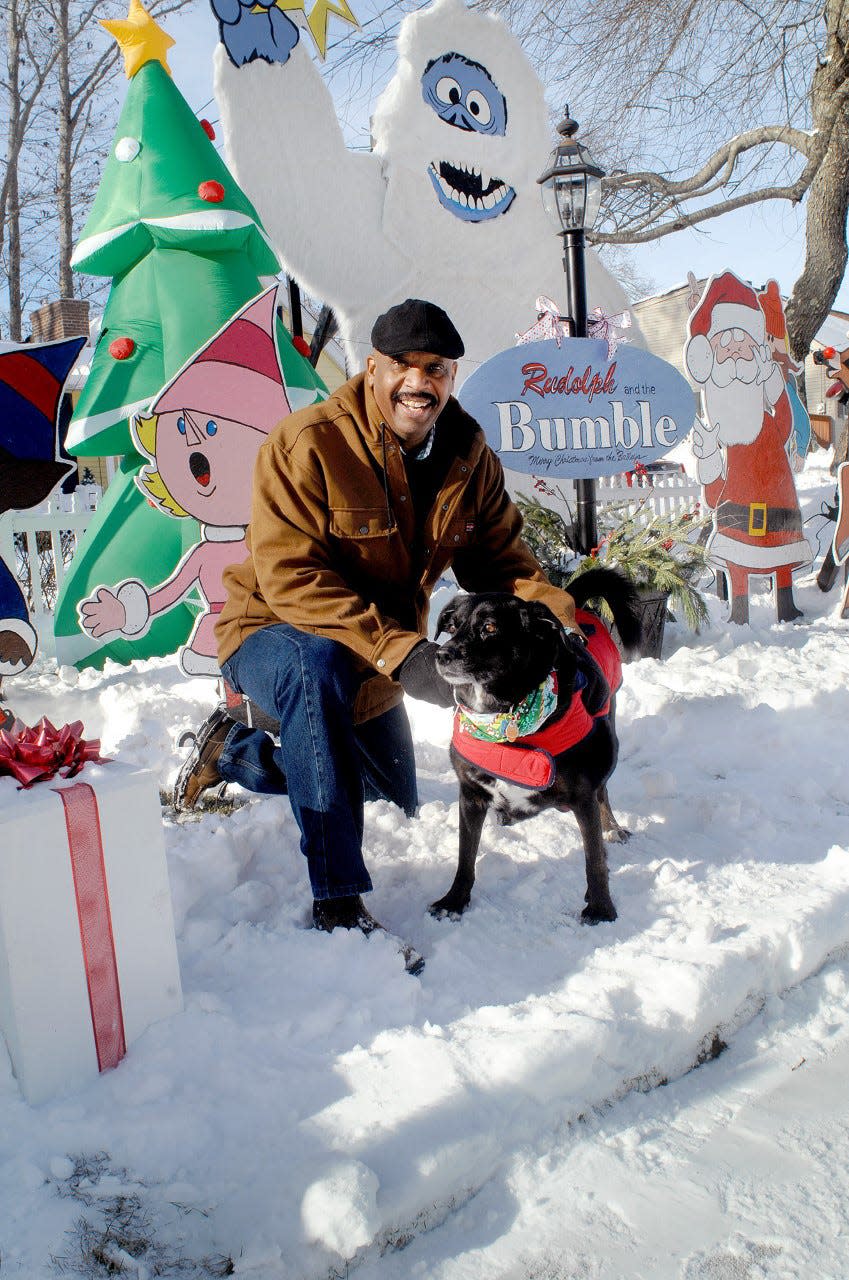 Al Bailey of Ocean Road in Portsmouth, seen with his dog Max on Dec. 19, 2020, created a "Rudolph the Red-Nosed Reindeer" display, as well as displays for his neighbors.