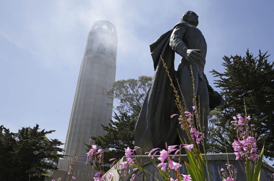 FILE - In this May 14, 2014, file photo, a statue of Christopher Columbus stands beneath Coit Tower in San Francisco. The statue in San Francisco was defaced with red paint and graffiti, the day before a federal holiday celebrating the 15th century Italian navigator. Officials say the statue at the foot of Coit Tower in the city's North Beach neighborhood was vandalized sometime Saturday night or Sunday morning. Someone poured red paint over it and drew anarchy symbols and messages on the concrete base that read "Destroy all monuments of genocide" and "Kill all colonizers." City workers cleaned the statue Sunday, Oct. 13, 2019, as thousands celebrated Italian culture. (AP Photo/File)