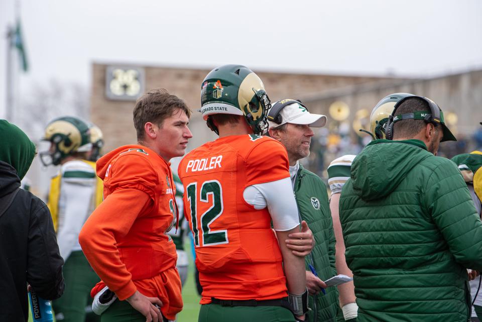 Colorado State University quarterbacks Brayden Fowler-Nicolosi (16) and Giles Pooler (12) join a huddle during the Green and Gold Spring Game on Saturday at Canvas Stadium in Fort Collins.