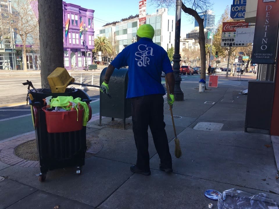 Castro CBD employee cleaning the sidewalk.