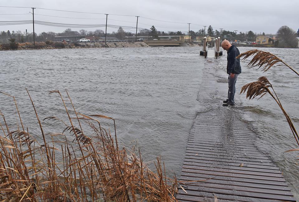 Bryan Vadeboncoeur walks through his flooded backyard at 48 Lee's River Drive in Swansea Monday Dec. 18, 2023.