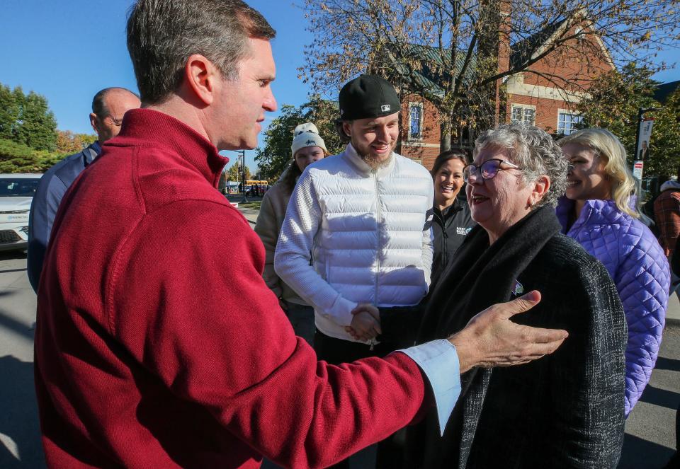 Governor Andy Beshear and rapper Jack Harlow are greeted by UofL President Kim Schatzel on the campaign trail at the University of Louisville on Thursday, November 2, 2023