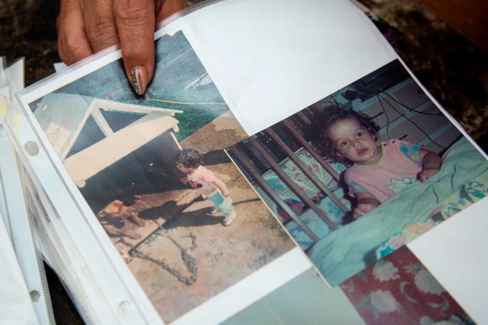 Elba Santos, mother of Angie González, shows photos from a large binder filled with images of her daughter that she has been making for years on March 21, 2021.