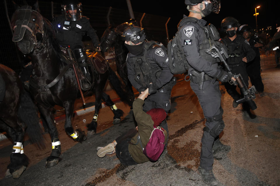 Israeli police officers detain a Palestinian demonstrator during a protest against the planned evictions of Palestinian families in the Sheikh Jarrah neighborhood of east Jerusalem, Saturday, May 8, 2021. (AP Photo/Oded Balilty)