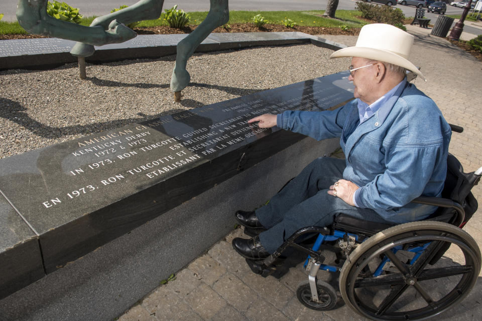 Ron Turcotte, who rode Secretariat to the Triple Crown in 1973, is shown next to a monument of him and Secretariat in Grand Falls, New Brunswick, Canada, on Wednesday, May 31, 2023. (AP Photo/Stephen MacGillivray)