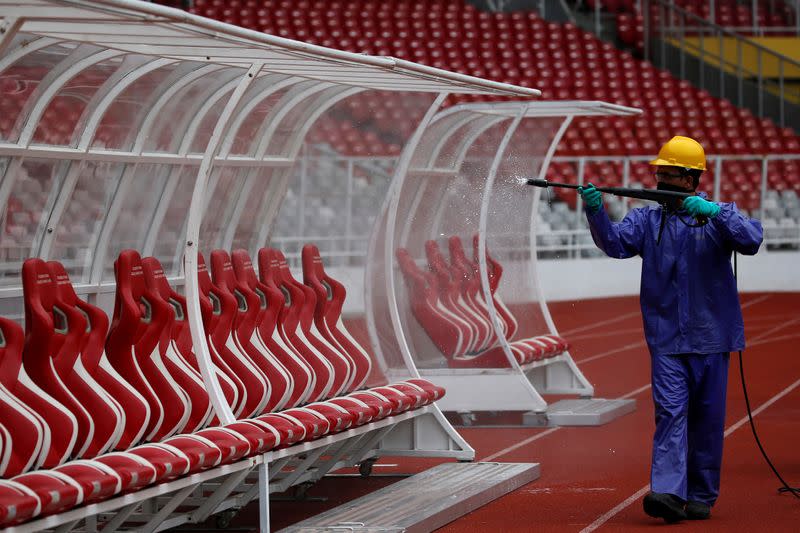 Worker sprays disinfectant at Gelora Bung Karno main stadium after Indonesia's capital began a two-week emergency period to prevent the spread of coronavirus disease (COVID-19) in Jakarta