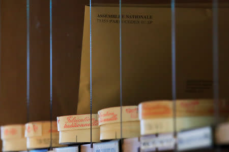 Boxes of a non-pasteurized French Camembert cheese are seen in mailboxes at the National Assembly in Paris, France, March 13, 2019. REUTERS/Gonzalo Fuentes