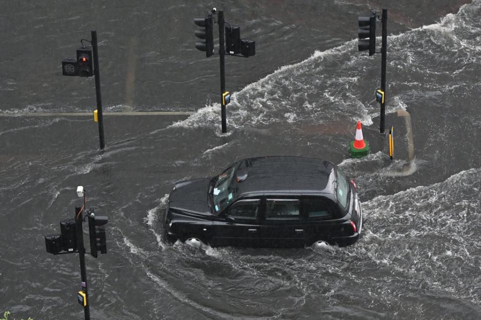 A London taxi struggles to drive though floodwaters (Justin Tallis/AFP/Getty Images)