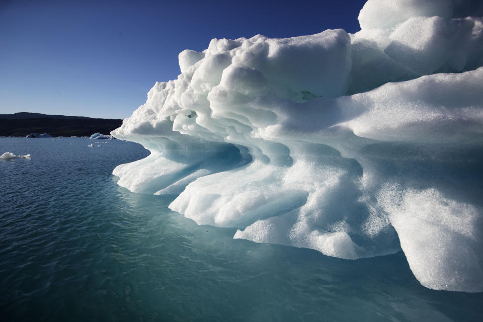 An icebergs floats in the Nuup Kangerlua Fjord near Nuuk in southwestern Greenland, Tuesday Aug. 1, 2017. Greenland's glaciers have been melting and retreating at an accelerated pace in recent years due to warmer temperatures. If all of that ice melts, sea levels will rise by several meters, though there will be regional differences. (AP Photo/David Goldman)