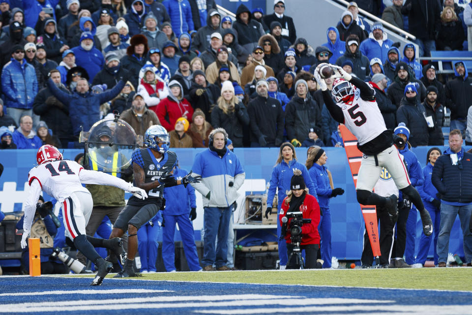 Georgia defensive back Kelee Ringo (5) intercepts a pass intended for Kentucky wide receiver Barion Brown (2) during the first half of an NCAA college football game in Lexington, Ky., Saturday, Nov. 19, 2022. (AP Photo/Michael Clubb)
