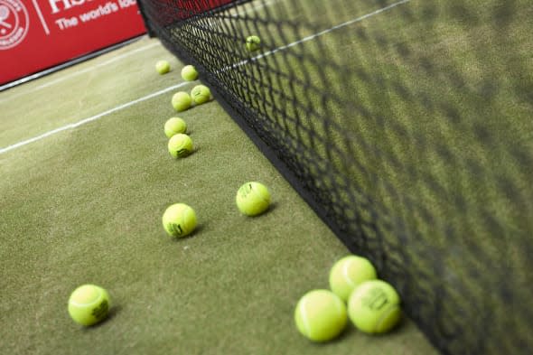 Tennis balls can be seen on a grass tennis court that was setup in Rockefeller Center. Champion tennis players Monica Seles and