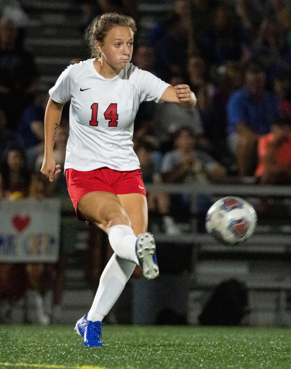 Center Grove Trojans defender Addie Crowe (14) kicks the ball Sept. 21, 2022, at Carmel High School in Carmel.  