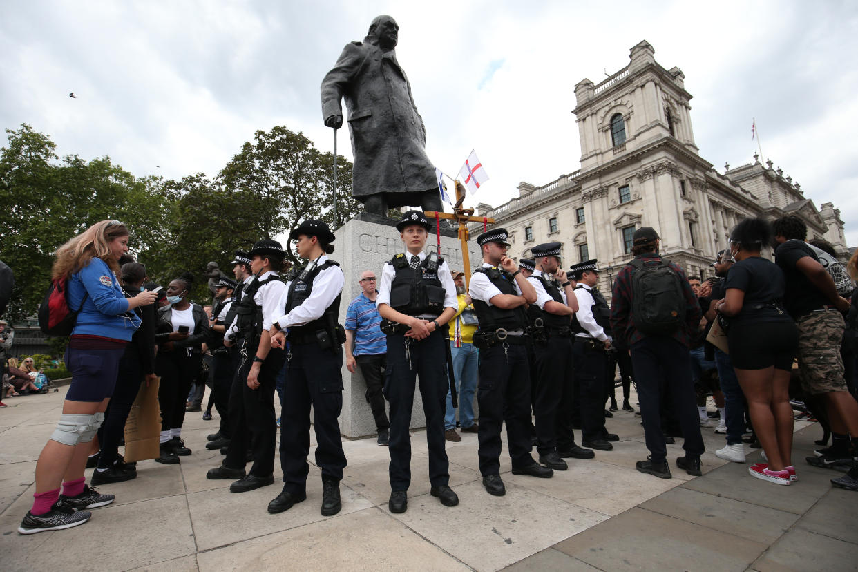 Police form up around the Sir Winston Churchill statue in Parliament Square, London, ahead of a rally at the Nelson Mandela statue in the square, to commemorate George Floyd, as his funeral takes place in the US following his death on May 25 while in police custody in the US city of Minneapolis.