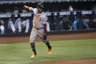 Atlanta Braves' Ronald Acuna Jr. celebrates as he scores on a double by Ozzie Albies during the third inning of the team's baseball game against the Miami Marlins, Friday, June 11, 2021, in Miami. (AP Photo/Wilfredo Lee)