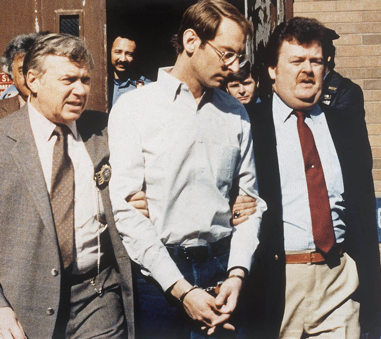 Bernard Goetz is escorted to his arraignment in New York in 1985, to be charged in the subway shootings of four youths. 