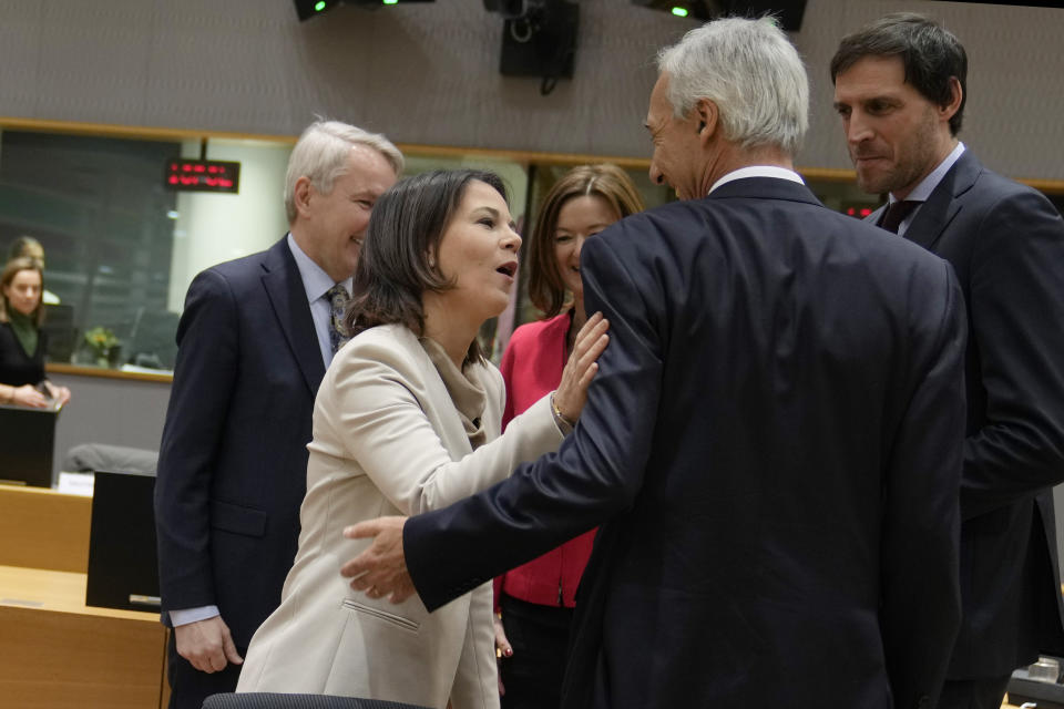 Germany's Foreign Minister Annalena Baerbock, second left, speaks with Portugal's Foreign Minister Augustos Santos Silva, second right, Netherland's Foreign Minister Wopke Hoekstra, right, and Finland's Foreign Minister Pekka Haavisto, left, during a round table meeting of EU foreign ministers at the European Council building in Brussels on Monday, Jan. 23, 2023. EU foreign ministers are meeting to discuss support for Ukraine, including more money to help buy weapons, and the crackdown on demonstrators in Iran. (AP Photo/Virginia Mayo)