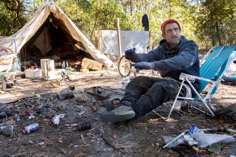 Tom Tom, one of the unhoused living off Beggs Lane, describes living at the campsite near the Escambia Wood Superfund site off Palafox Street on Friday, Feb. 2, 2024.