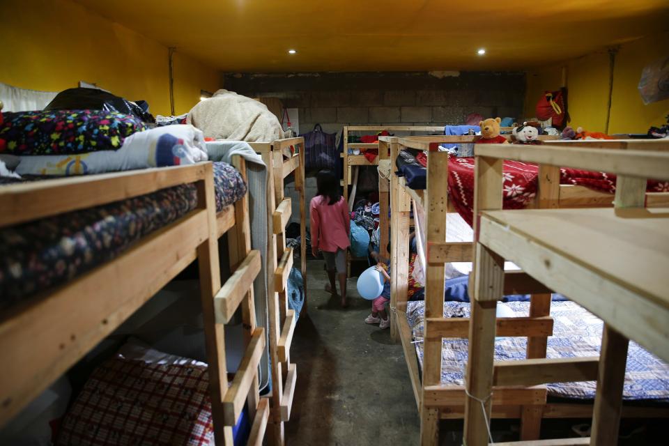 A girl walks inside a bedroom at the Agape World Mission shelter used mostly by Mexican and Central American migrants who are applying for asylum in the U.S., on the border in Tijuana, Mexico, Monday, June 10, 2019. The mechanism that allows the U.S. to send migrants seeking asylum back to Mexico to await resolution of their process has been running in Tijuana since January. (AP Photo/Eduardo Verdugo)