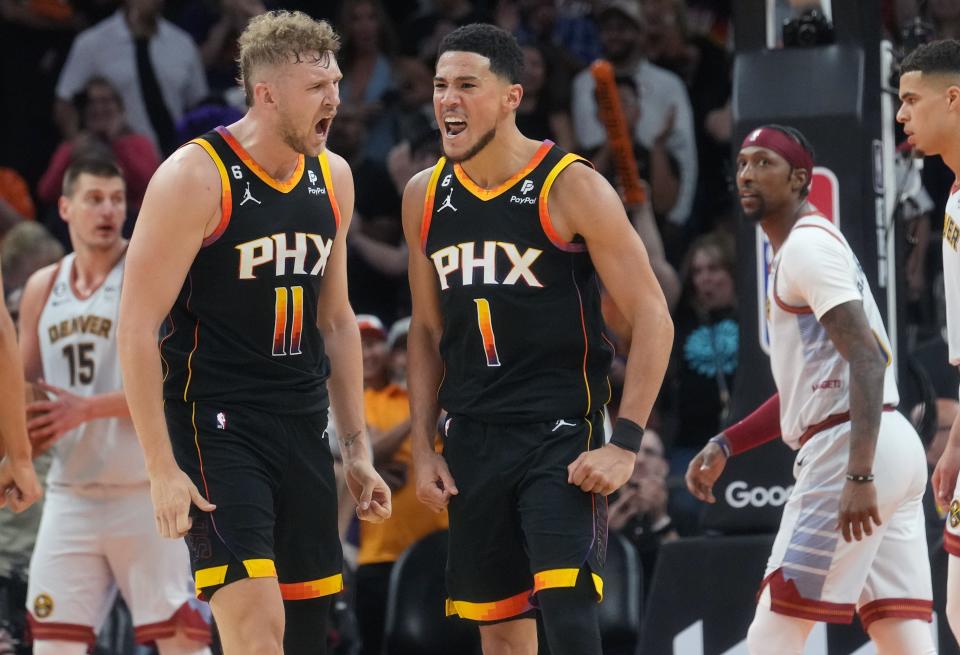 May 5, 2023; Phoenix, AZ, USA; Phoenix Suns guard Devin Booker (1) celebrates his made shot with teammate Jock Landale (11) against the Denver Nuggets during Game 3 of the Western Conference Semifinals at the Footprint Center. 