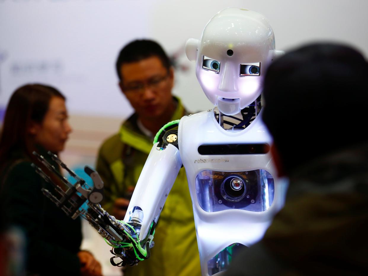 People look at a RoboThespian humanoid robot at the Tami Intelligence Technology stall at the WRC 2016 World Robot Conference in Beijing, China, October 21, 2016. REUTERS/Thomas Peter