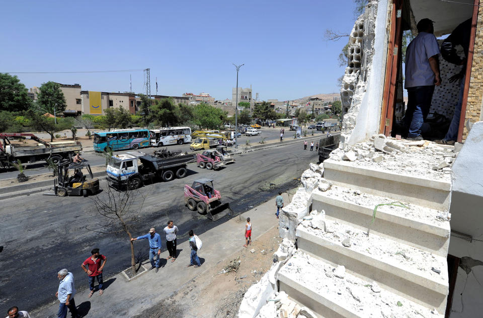 <p>People inspect the damage at a blast site in the Baytara traffic circle near the Old City of Damascus, Syria July 2, 2017. (Omar Sanadiki/Reuters) </p>