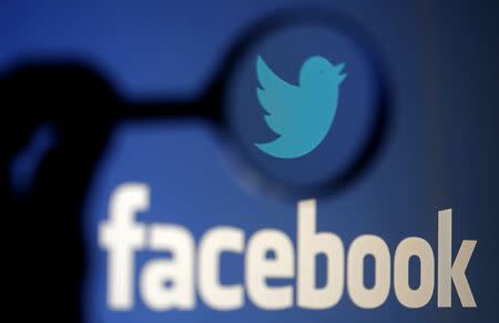 A logo of Twitter is pictured next to the logo of Facebook in this September 23, 2014 illustration photo in Sarajevo. REUTERS/Dado Ruvic/Files