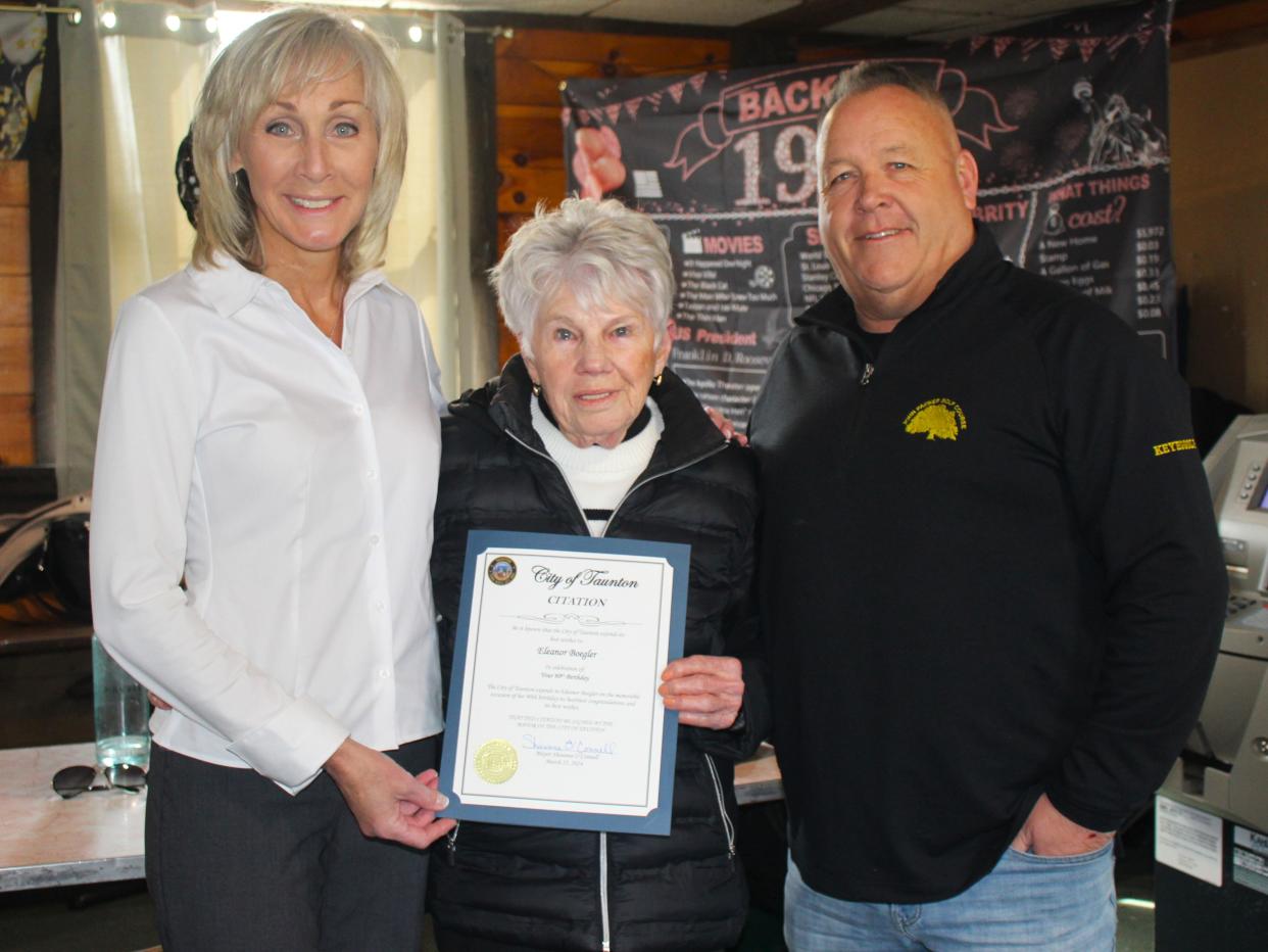 Ellie Boegler (center) poses with Taunton Mayor Shaunna O'Connell (left) and John F. Parker Golf Course Supervisor Ed Keyes (right) after being presented with a citation honoring her 90th birthday during a celebration on March 25, 2024.