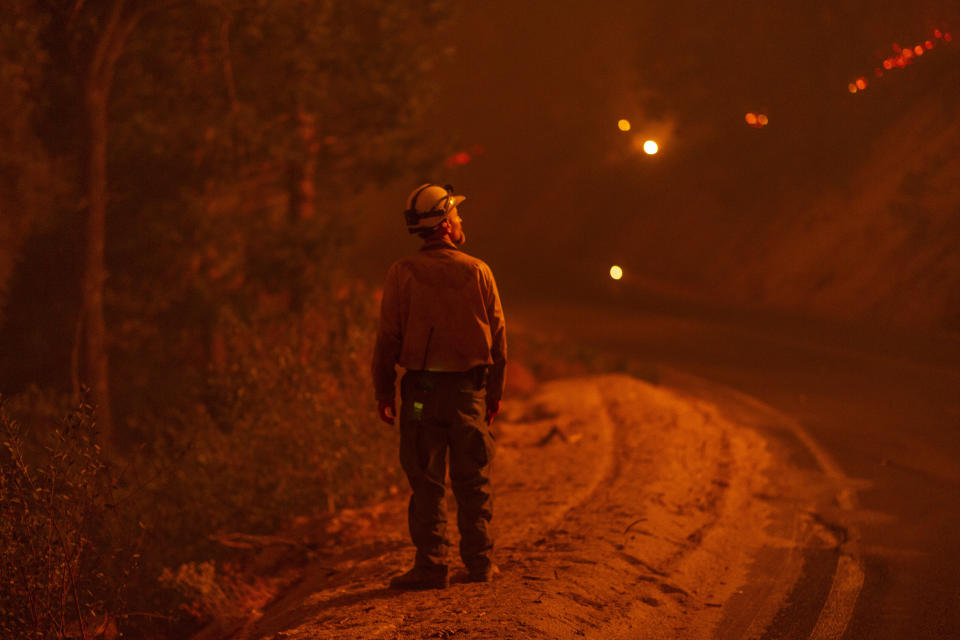 A firefighter keeps watch as flames advance along the Western Divide Highway during the SQF Complex Fire on September 14, 2020, near Camp Nelson, California. Worsening wildfires across the U.S. West are among the more visible signs of global warming. (Photo: David McNew via Getty Images)