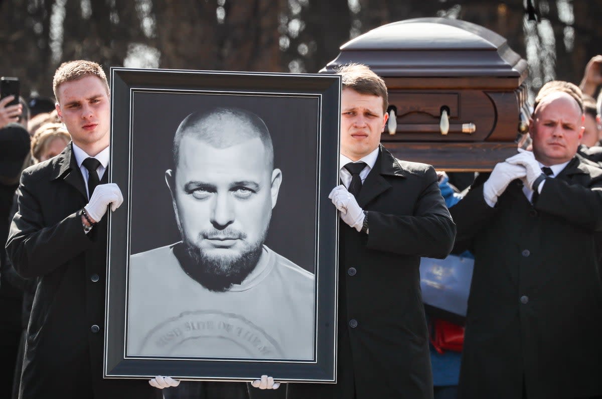 Pallbearers carry a picture and the coffin with the body of Tatarsky, at the Troekurovsky cemetery in Moscow last year (EPA)
