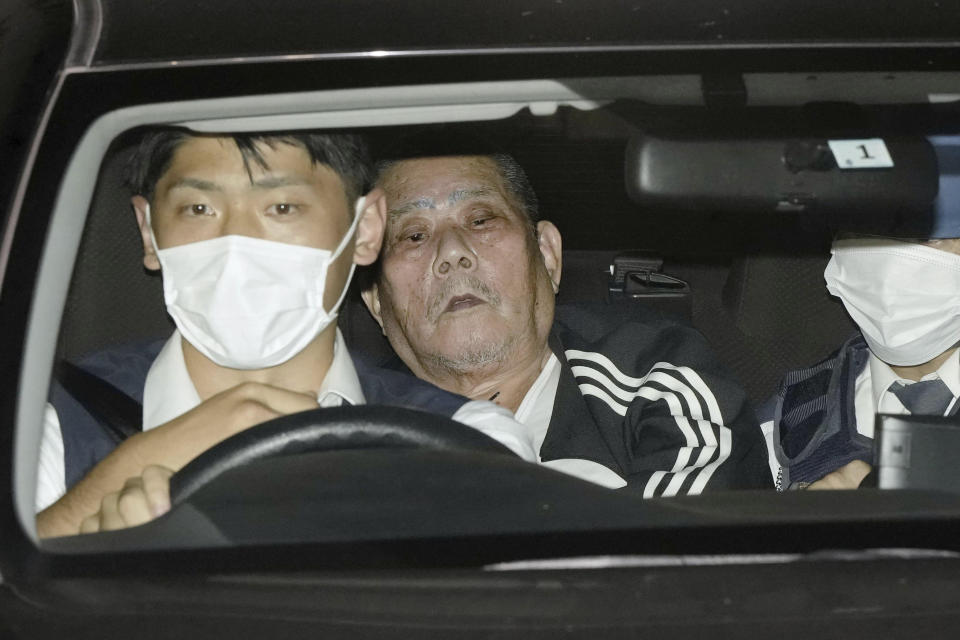 A suspect, center, identified as Tsuneo Suzuki, who barricaded himself with a gun at a post office, arrives at a police station in Warabi, north of Tokyo Tuesday, Oct. 31, 2023. Police ended an eight-hour standoff with the gunman at a post office Tuesday by arresting the suspect after two hostages were freed safely in an attack authorities said could be related to an earlier shooting at a hospital. (Kyodo News via AP)