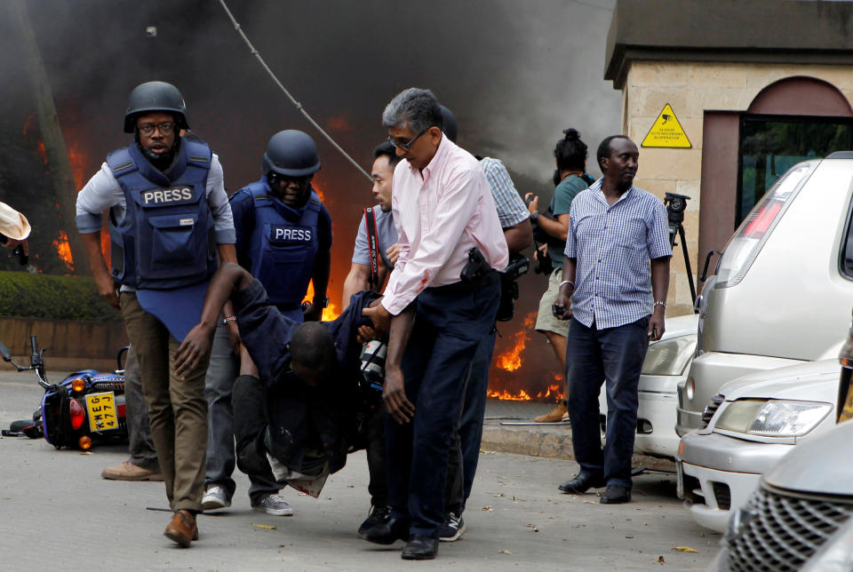 Rescuers and journalists evacuate an injured man after explosions and gunshots were heard at the Dusit hotel compound in Nairobi, Kenya, Jan. 15, 2019. (Photo: Njeri Mwangi/Reuters)