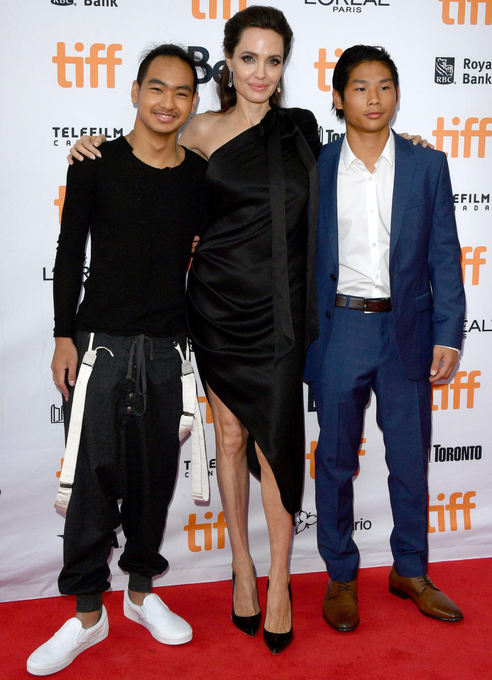<p>Thanks to their special behind-the-scenes status, Jolie's older sons got a special red carpet pic with Mom, too! “They worked hard,” <span>Jolie told <em>ET</em></span> of her two oldest kids.</p>