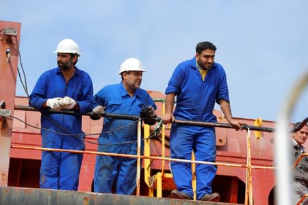 Members of the crew of the Iranian vessel Bavand are seen near the port of Paranagua
