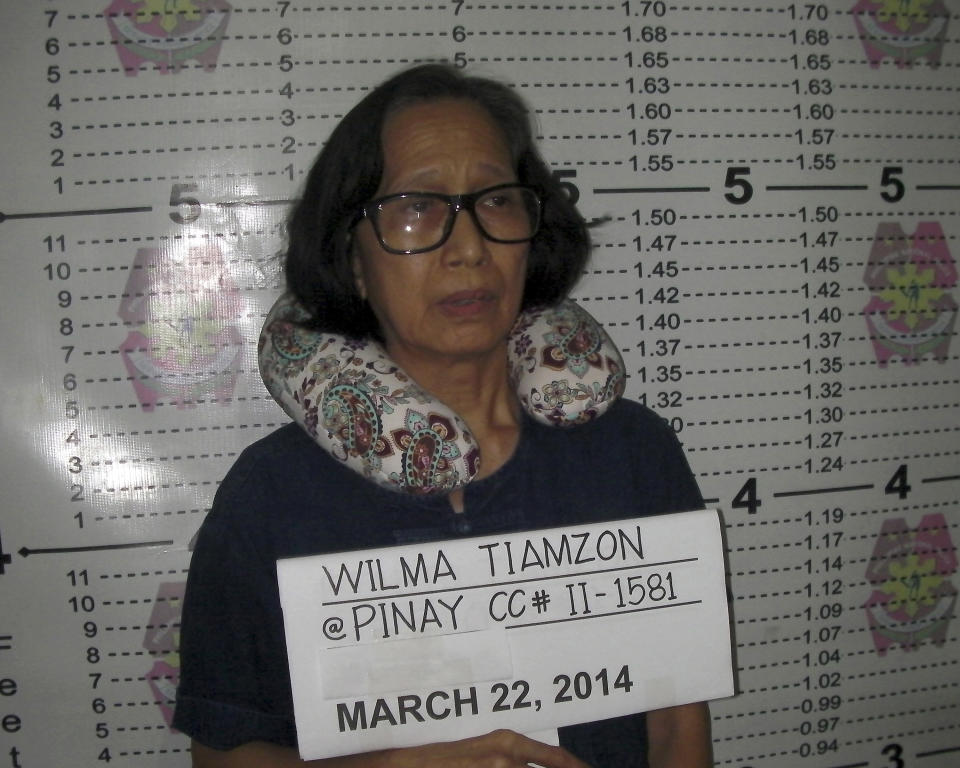 In this Saturday, March 22, 2014 photo released by the Philippine National Police Public Information Office, suspected communist leader, Wilma Austria Tiamzon, has her mugshot taken in Cebu province, central Philippines. Philippine officials said Sunday that they would not release two leaders of a violent rebel group fighting to overthrow the government, whose arrests were a serious blow to one of Asia's longest-running communist insurgencies. (AP Photo/Philippine National Police, Public Information Office)