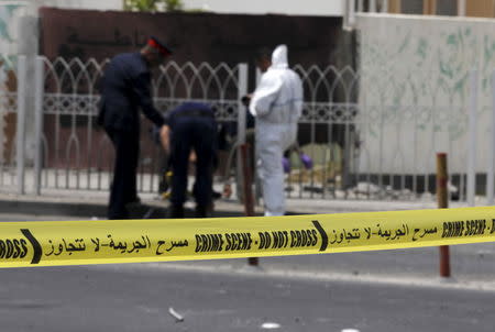 Explosives specialist police conduct their investigation after a bomb blast in the village of Sitra, south of Manama, Bahrain, July 28, 2015. REUTERS/Hamad I Mohammed