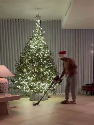 <p>Nicola Peltz/TikTok</p> David Beckham works the vacuum during family Christmas gathering