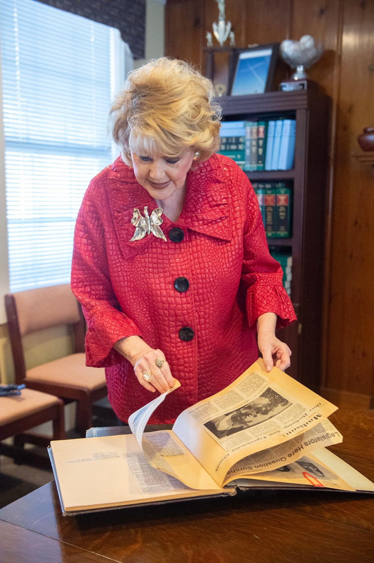Madison Mayor Mary Hawkins Butler flips through one of her scrapbooks at city hall on Monday, Dec. 11. The scrapbooks trace her career from antique dealer to alderman to mayor.