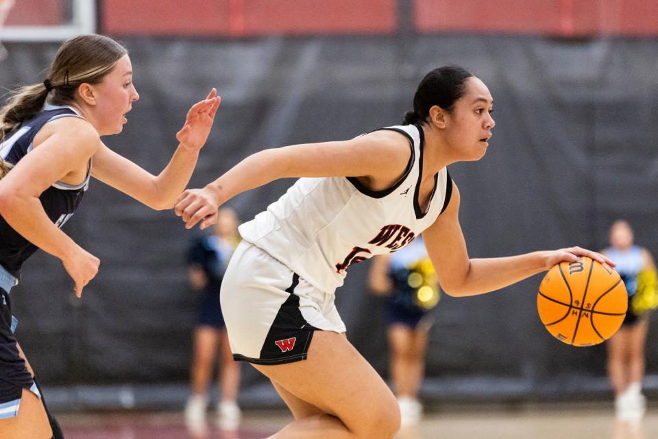 West Panthers forward/guard Fine Tuha (14) dribbles the ball past Salem Hills Skyhawks’ Madi King (24) during a game at West High School in Salt Lake City on Thursday, Feb. 22, 2024. | Marielle Scott, Deseret News