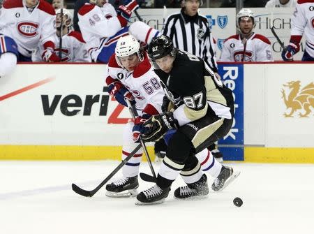 Jan 3, 2015; Pittsburgh, PA, USA; Montreal Canadiens right wing Sven Andrighetto (58) and Pittsburgh Penguins center Sidney Crosby (87) battle for the puck during the second period at the Consol Energy Center. Mandatory Credit: Matthew O'Haren-USA TODAY Sports