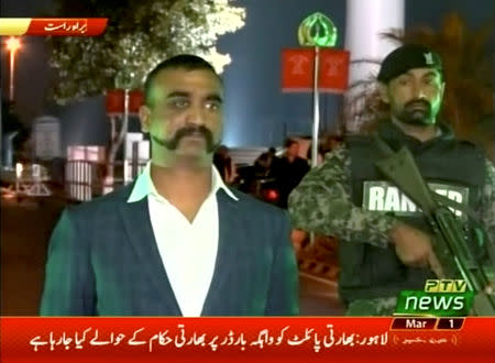 FILE PHOTO: Indian pilot, Wing Commander Abhinandan, stands under armed escort near Pakistan-India border in Wagah, Pakistan in this March 1, 2019 image from a video footage. REUTERS/PTV via Reuters TV/File Photo