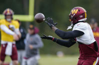 Washington Commanders running back Brian Robinson Jr., catches a pass during practice at the team's NFL football training facility, Wednesday, Oct. 5, 2022, in Ashburn, Va. Robinson was shot twice in the right leg Aug. 28 in Washington, was taken to a hospital, underwent surgery and was released a day later. The bullets missed all the major ligaments and bones in his knee. (AP Photo/Alex Brandon)