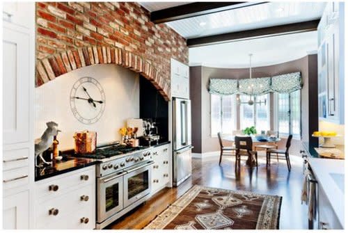 With beam ceilings, wood floods, and a brick hearth, the kitchen style of this San Francisco home is country chic. Source: Christie's Real Estate