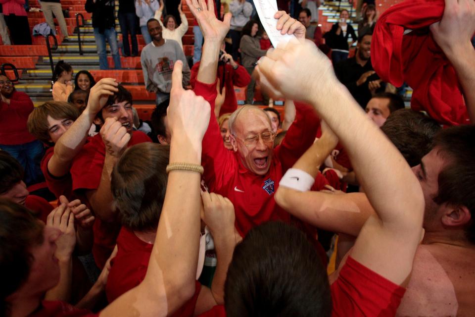 Surrounded by Thomas Worthington High School students at the end of their game against Delaware Hayes High School Bob Miller, coach of the Worthington High School Boys Basketball celebrate his 500th career win as coach Jan. 22, 2008, at Delaware Hayes High School. 
(Credit: Columbus Dispatch file photo)