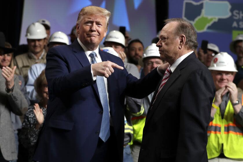 President Donald Trump gestures to Harold Hamm, CEO and majority owner of North Dakota's largest oil company, Continental Resources, as he arrives to speak at the 9th annual Shale Insight Conference at the David L. Lawrence Convention Center, Wednesday, Oct. 23, 2019, in Pittsburgh. (AP Photo/Evan Vucci)